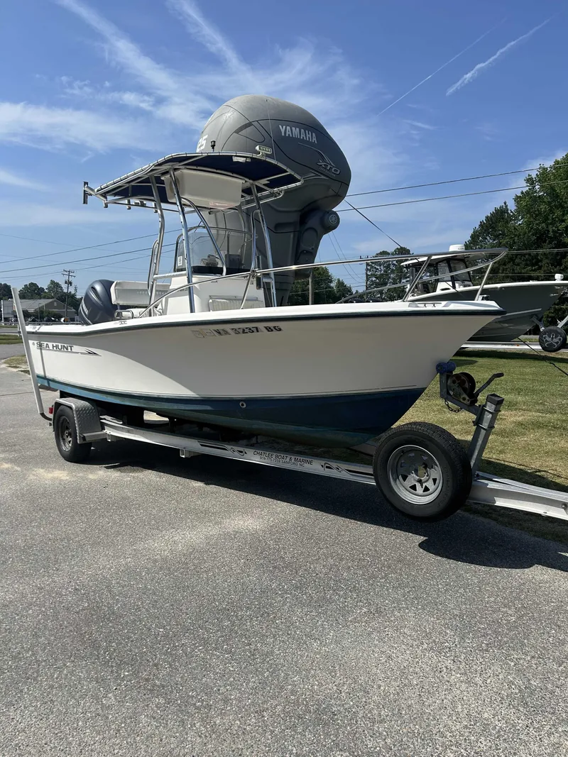 The Image of A 2005 Sea Hunt Triton 202 boat on a trailer, featuring a Yamaha outboard motor. - 1