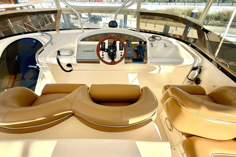 Slide: The Image of Cockpit of 2000 Fairline Squadron 55 yacht with tan leather seats and Garmin navigation. - 22