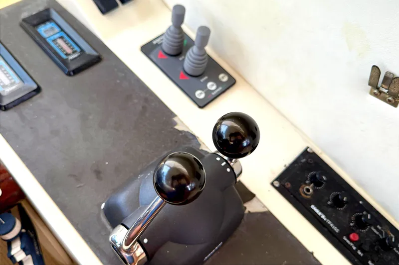 Slide: The Image of Control panel of a 2000 Fairline Squadron 55 yacht with throttle levers. - 24