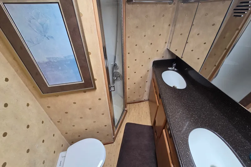 Slide: The Image of Luxurious bathroom in 2005 Cavileer 44 Convertible yacht with dual sinks and shower. - 23