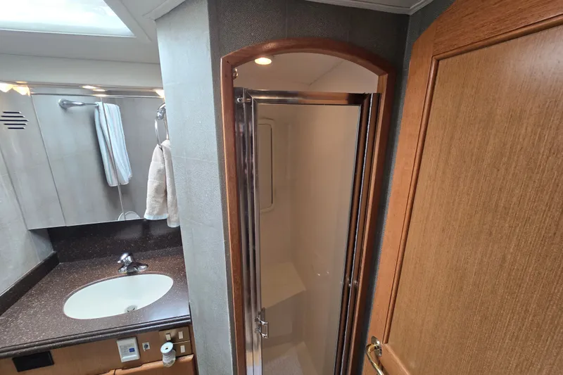 Slide: The Image of Luxurious bathroom interior of 2005 Cavileer 44 Convertible yacht with shower and sink. - 27