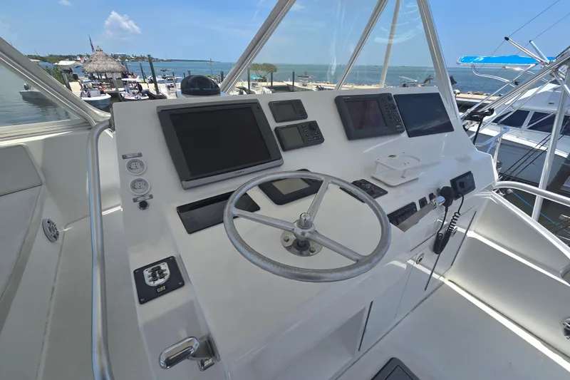 Slide: The Image of Helm of 2005 Cavileer 44 Convertible yacht with navigation equipment and ocean view. - 9