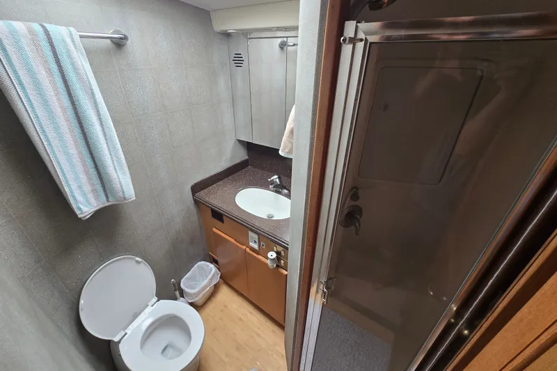 Slide: The Image of Bathroom interior of 2005 Cavileer 44 Convertible yacht with sink, toilet, and shower. - 25