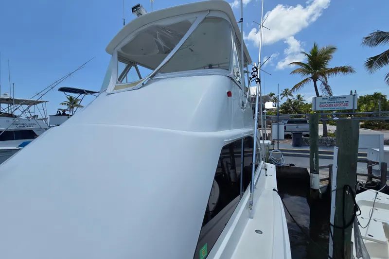 Slide: The Image of 2005 Cavileer 44 Convertible yacht docked under clear blue sky. - 40