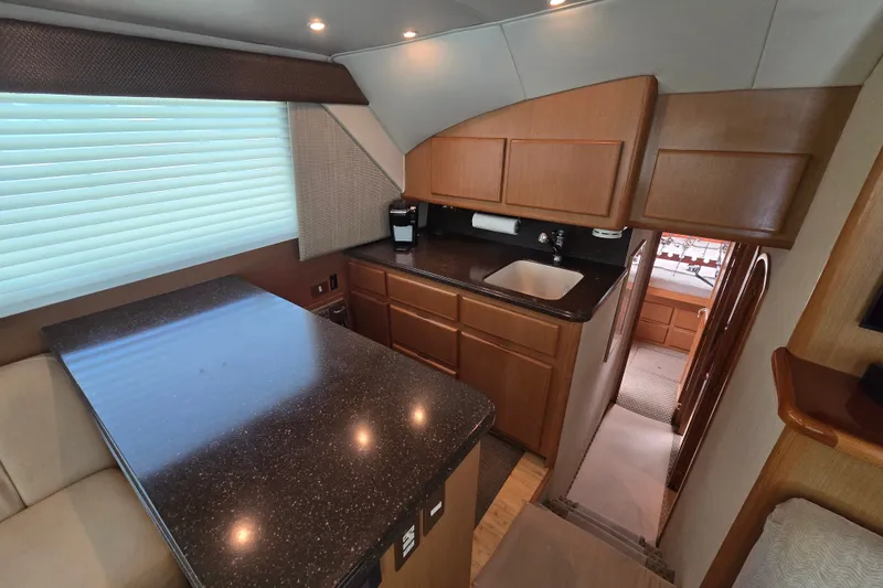 Slide: The Image of 2005 Cavileer 44 Convertible yacht interior with modern kitchen and sleek countertops. - 21