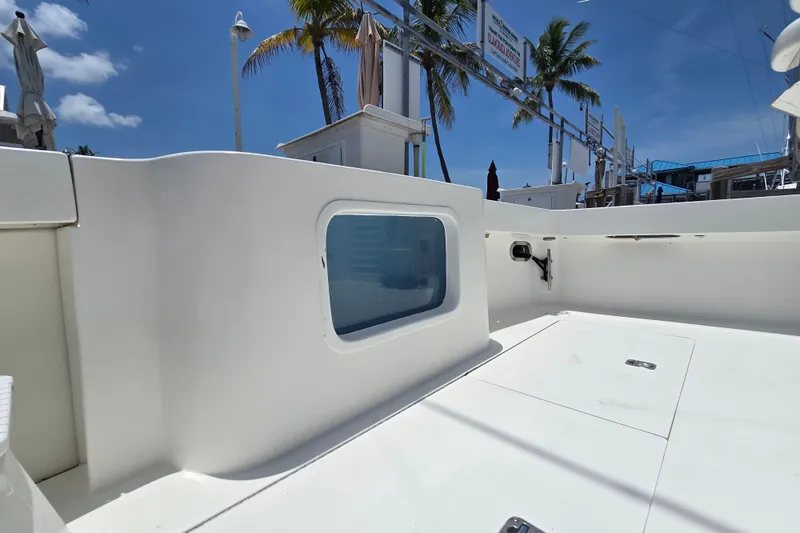 Slide: The Image of 2005 Cavileer 44 Convertible yacht deck with clear sky and palm trees. - 35