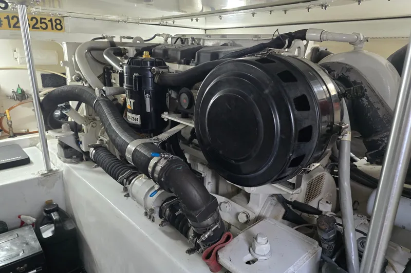 Slide: The Image of Engine room of a 2005 Cavileer 44 Convertible yacht, showcasing mechanical components. - 41