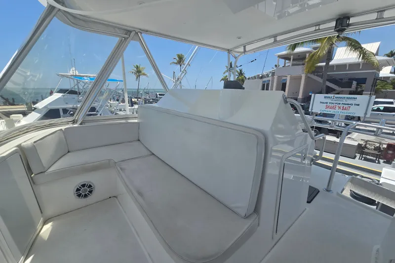 Slide: The Image of 2005 Cavileer 44 Convertible yacht interior with seating, docked at marina. - 11
