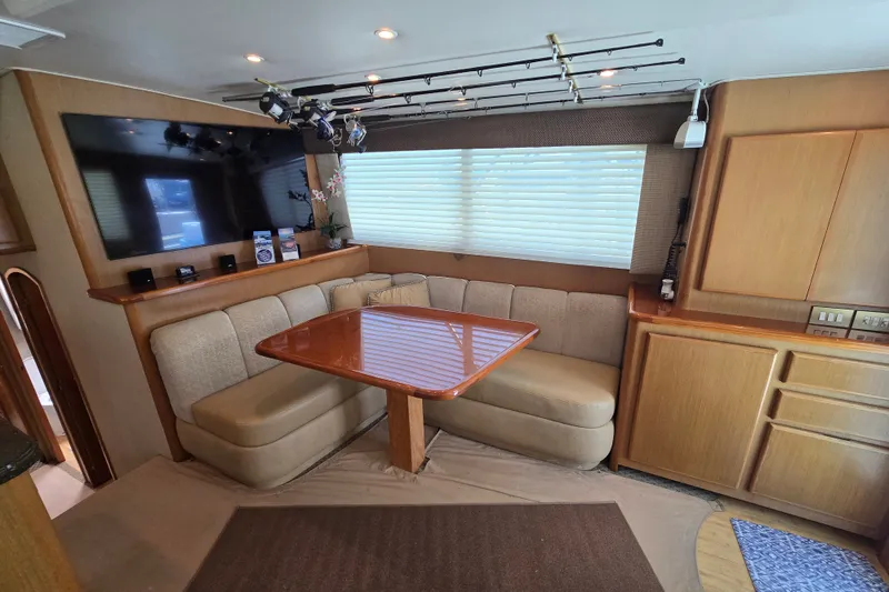 Slide: The Image of Interior of 2005 Cavileer 44 Convertible yacht with cozy seating and mounted TV. - 15