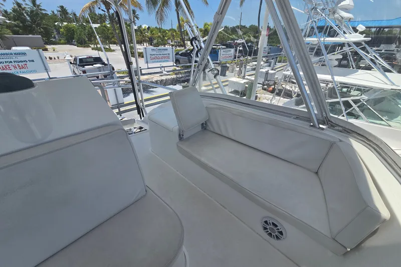 Slide: The Image of 2005 Cavileer 44 Convertible yacht interior with seating, docked at marina. - 12