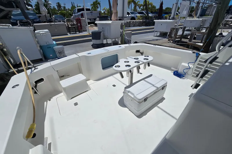 Slide: The Image of 2005 Cavileer 44 Convertible boat deck with fishing rod holders and cooler. - 33