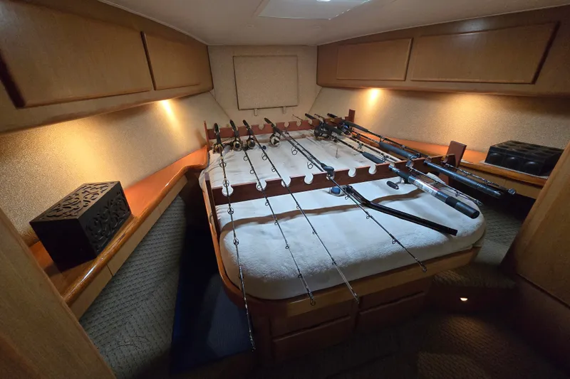 Slide: The Image of Interior of 2005 Cavileer 44 Convertible with fishing rods on bed. - 31