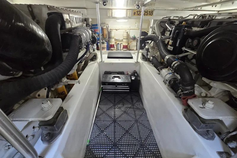 Slide: The Image of Engine room of a 2005 Cavileer 44 Convertible yacht, showcasing mechanical components and equipment. - 43