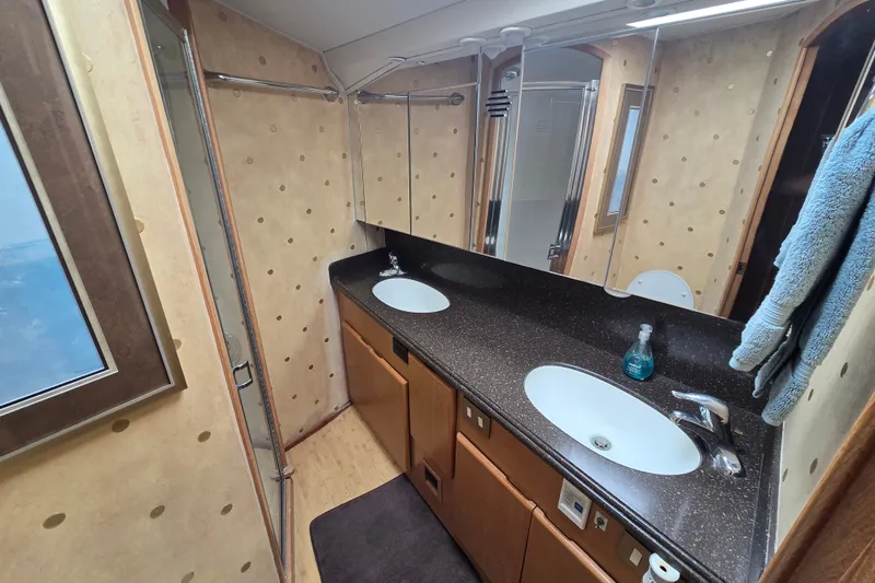 Slide: The Image of Luxurious bathroom in 2005 Cavileer 44 Convertible yacht with dual sinks and modern fixtures. - 22