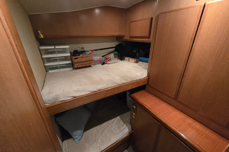 Slide: The Image of 2005 Cavileer 44 Convertible cabin with wooden interior and bunk beds. - 28