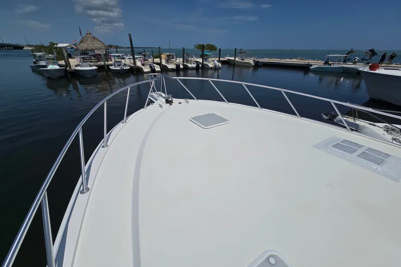 Slide: The Image of Bow view of 2005 Cavileer 44 Convertible yacht docked at marina. - 39
