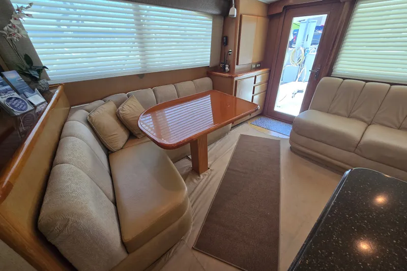 Slide: The Image of Luxurious interior of 2005 Cavileer 44 Convertible yacht with plush seating and wooden table. - 17