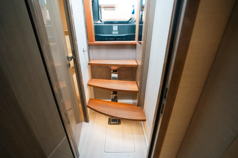 Slide: The Image of Interior stairs of 2022 Fjord 52 Open yacht, featuring wooden steps and modern design. - 33