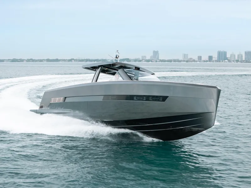 Slide: The Image of 2022 Fjord 52 Open yacht cruising on open water, city skyline in background. - 1