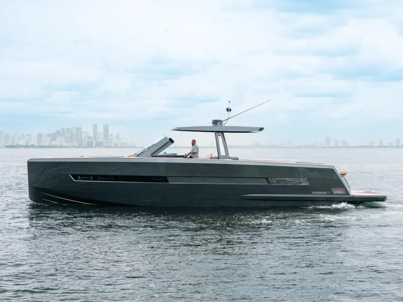 Slide: The Image of 2022 Fjord 52 Open yacht cruising on calm waters with city skyline in background. - 4