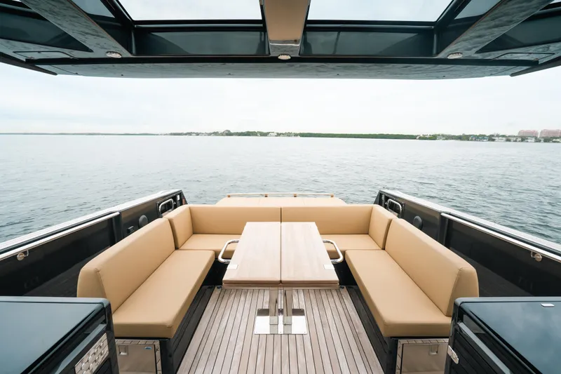 Slide: The Image of 2022 Fjord 52 Open yacht with spacious seating and table on open water. - 15