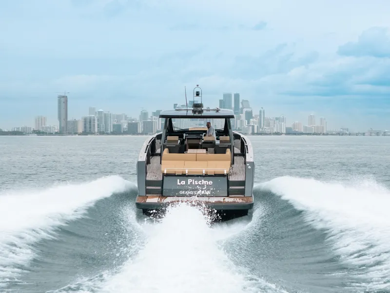 Slide: The Image of 2022 Fjord 52 Open yacht cruising with city skyline in the background. - 49