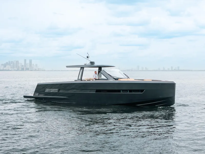 The Image of 2022 Fjord 52 Open yacht cruising on calm waters with city skyline in background. - 0