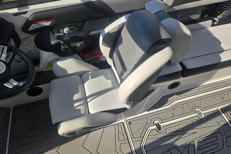 Slide: The Image of 2018 Nautique Super Air Nautique G25 interior with steering wheel and seating. - 13