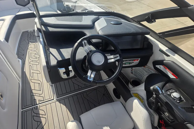 Slide: The Image of 2018 Nautique Super Air Nautique G25 cockpit with steering wheel and dashboard controls. - 12