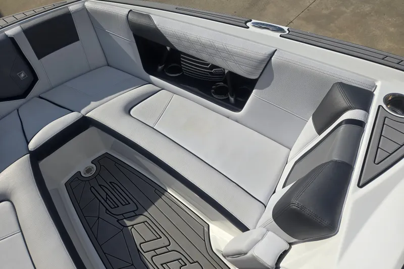 Slide: The Image of Interior seating of 2018 Nautique Super Air Nautique G25 boat, featuring sleek design and cup holders. - 4