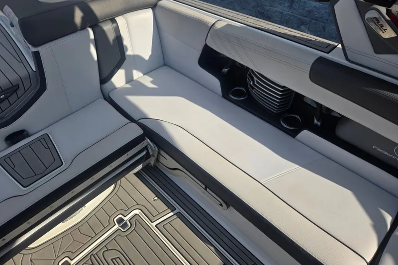 Slide: The Image of 2018 Nautique Super Air Nautique G25 interior with white seating and cup holders. - 9