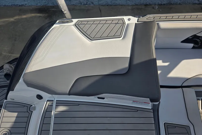 Slide: The Image of 2018 Nautique Super Air Nautique G25 boat interior with gray and white seating. - 17