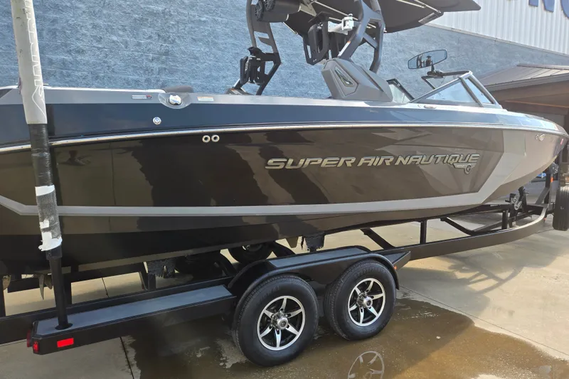 Slide: The Image of 2018 Nautique Super Air Nautique G25 boat on trailer, side view. - 1