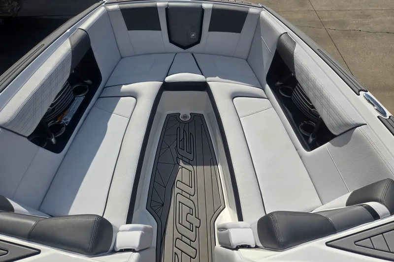 Slide: The Image of 2018 Nautique Super Air Nautique G25 boat interior with sleek seating and cup holders. - 3