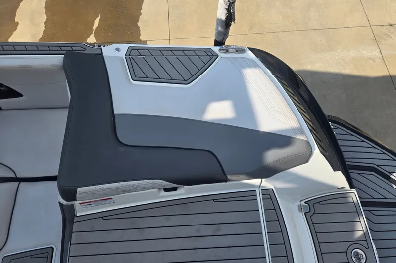 Slide: The Image of 2018 Nautique Super Air Nautique G25 boat interior, featuring sleek seating and deck design. - 16