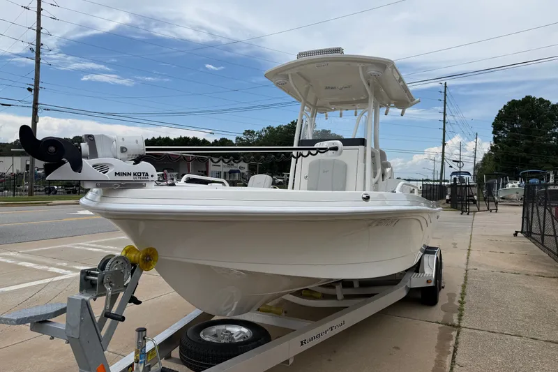 Slide: The Image of 2024 Ranger 2360 Bay boat on trailer, featuring Minn Kota Ulterra motor. - 16