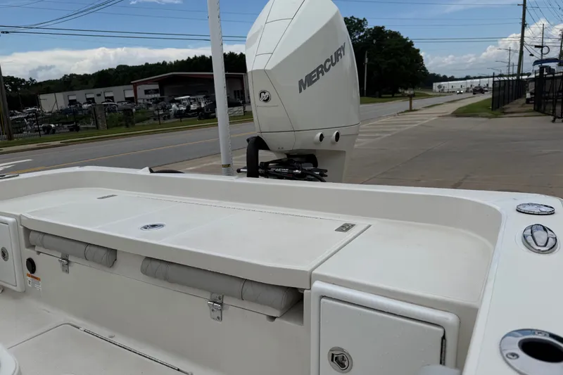Slide: The Image of 2024 Ranger 2360 Bay boat with Mercury engine, parked near a road. - 32