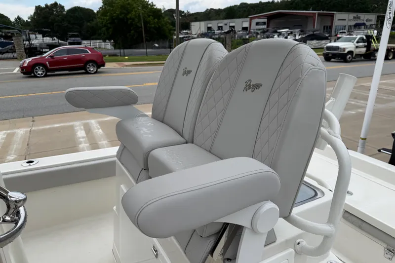 Slide: The Image of 2024 Ranger 2360 Bay boat with luxurious gray seating and armrests. - 24