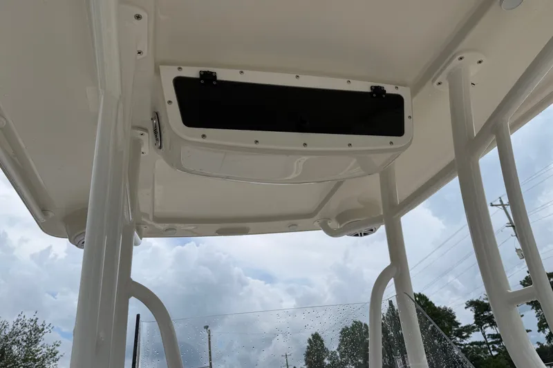 Slide: The Image of 2024 Ranger 2360 Bay boat's T-top interior with storage compartment and speakers. - 27