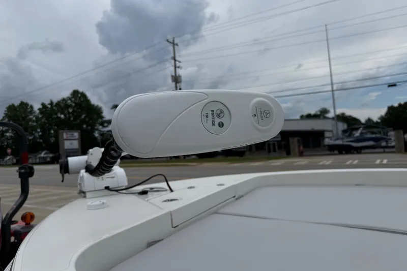 Slide: The Image of 2024 Ranger 2360 Bay boat with trolling motor, parked outdoors under cloudy skies. - 21