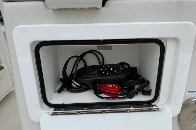 Slide: The Image of Storage compartment on 2024 Ranger 2360 Bay boat with electronic equipment inside. - 30