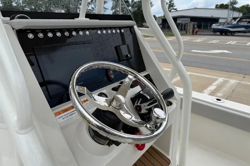 Slide: The Image of Steering console of 2024 Ranger 2360 Bay boat with chrome wheel and control panel. - 25