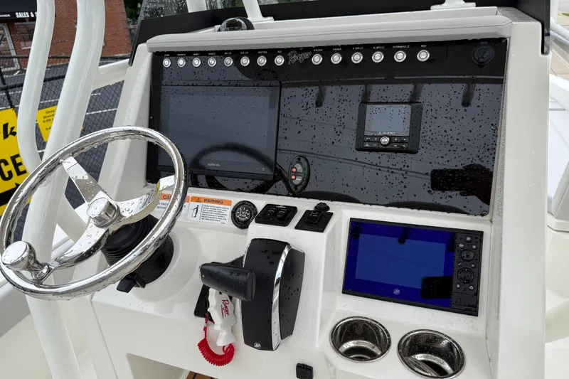 Slide: The Image of 2024 Ranger 2360 Bay boat dashboard with steering wheel and electronic controls. - 36