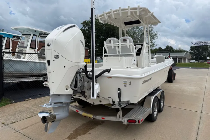 Slide: The Image of 2024 Ranger 2360 Bay boat on trailer, featuring a powerful outboard motor. - 14