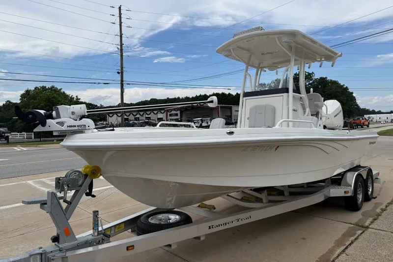 Slide: The Image of 2024 Ranger 2360 Bay boat on trailer, featuring Minn Kota trolling motor. - 17