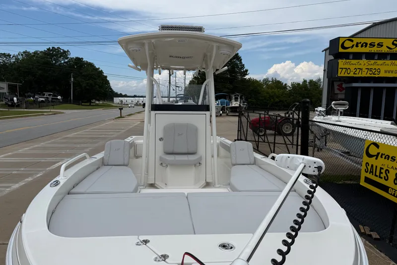 Slide: The Image of 2024 Ranger 2360 Bay boat displayed at a dealership, showcasing spacious seating and modern design. - 18