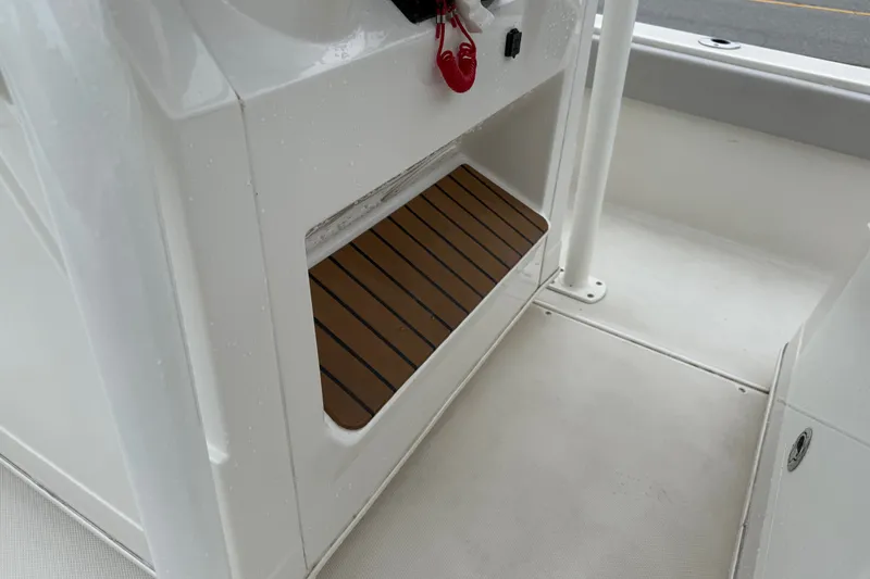 Slide: The Image of 2024 Ranger 2360 Bay boat interior with wooden step detail. - 29