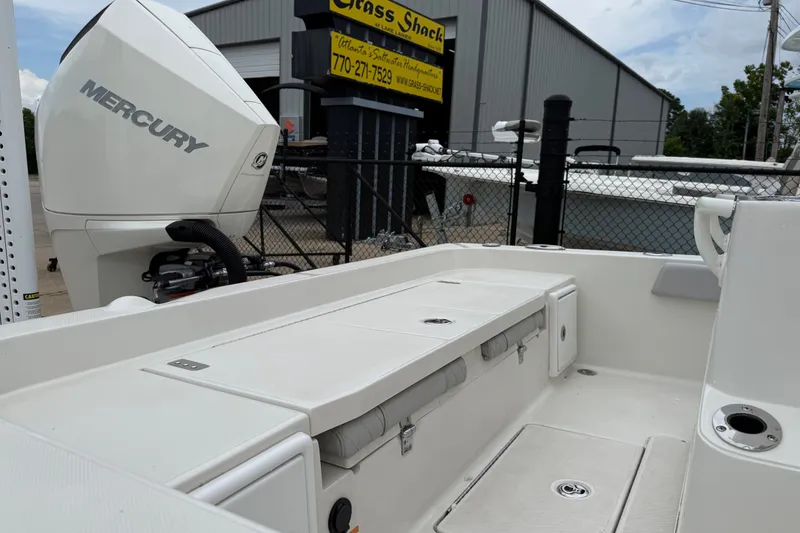 Slide: The Image of 2024 Ranger 2360 Bay boat with Mercury engine, displayed outdoors near a dealership. - 33