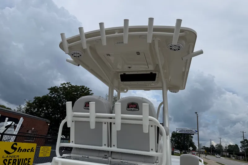 Slide: The Image of 2024 Ranger 2360 Bay boat with T-top and rod holders under cloudy sky. - 38