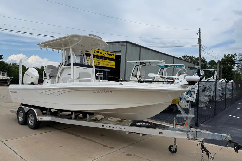 The Image of 2024 Ranger 2360 Bay boat on trailer, parked outside dealership. - 11